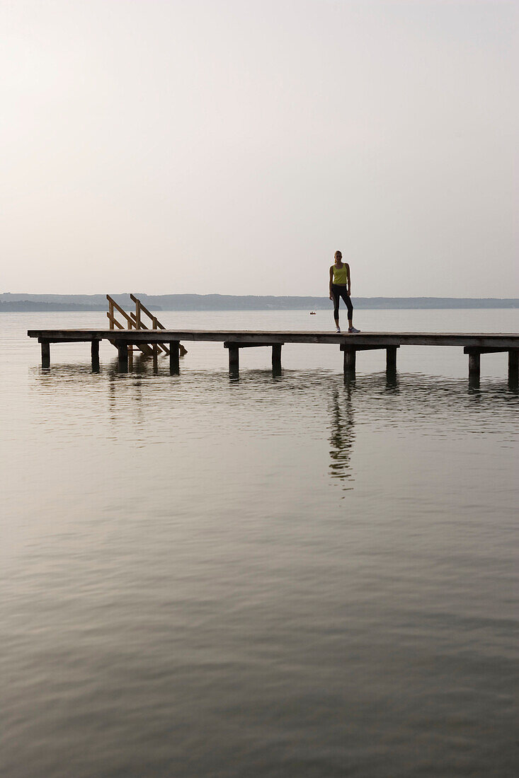 Young woman standing on jetty