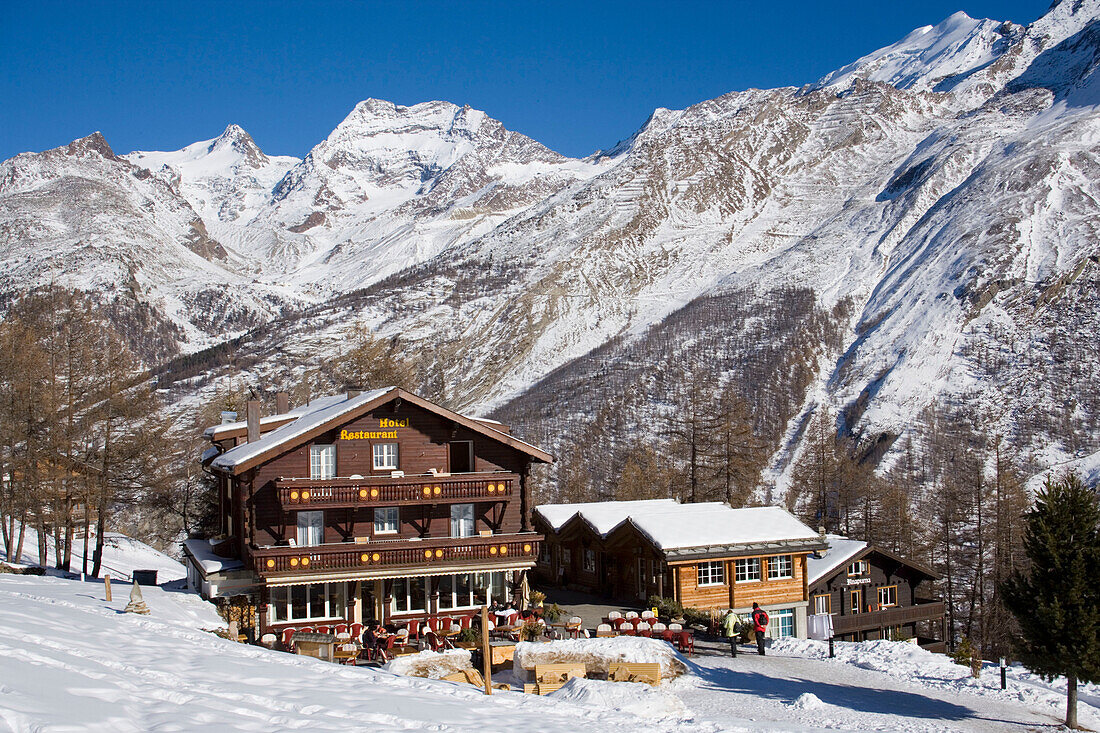 Hotel and Restaurant Hohnegg in front of a snowy mountain, Saas-Fee, Valais, Switzerland