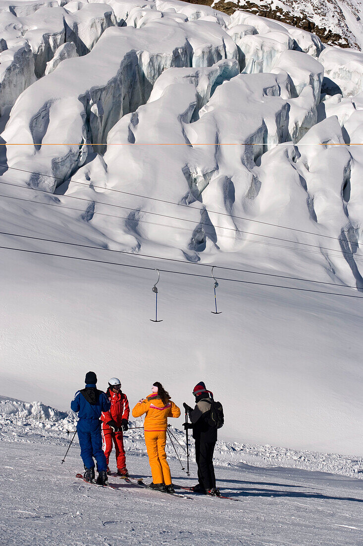 Group of skiers at the slope with instructor, before Fee Glacier near Laengfluh, Saas-Fee, Valais, Switzerland