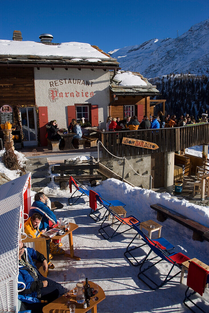 People sitting on terrace of Restaurant Paradies (2540 m), Findeln, Zermatt, Valais, Switzerland
