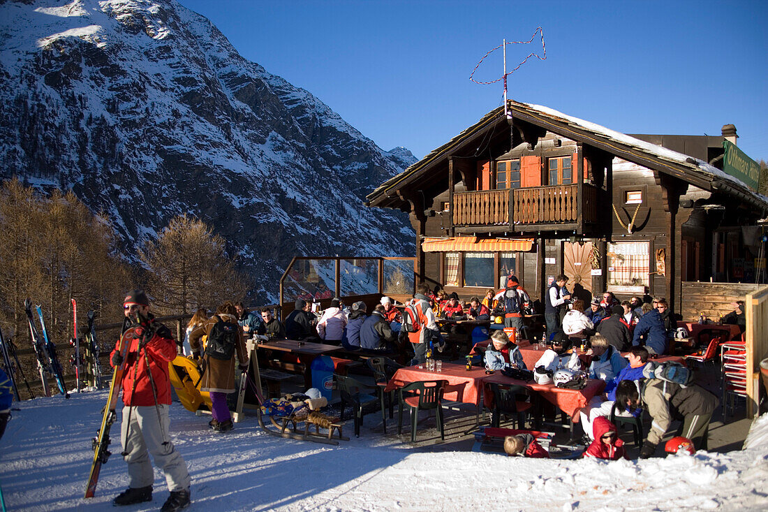 People sitting on terrace of the mountain restaurant "Othmar's Hütte", Sunnegga Paradise, Zermatt, Valais, Switzerland