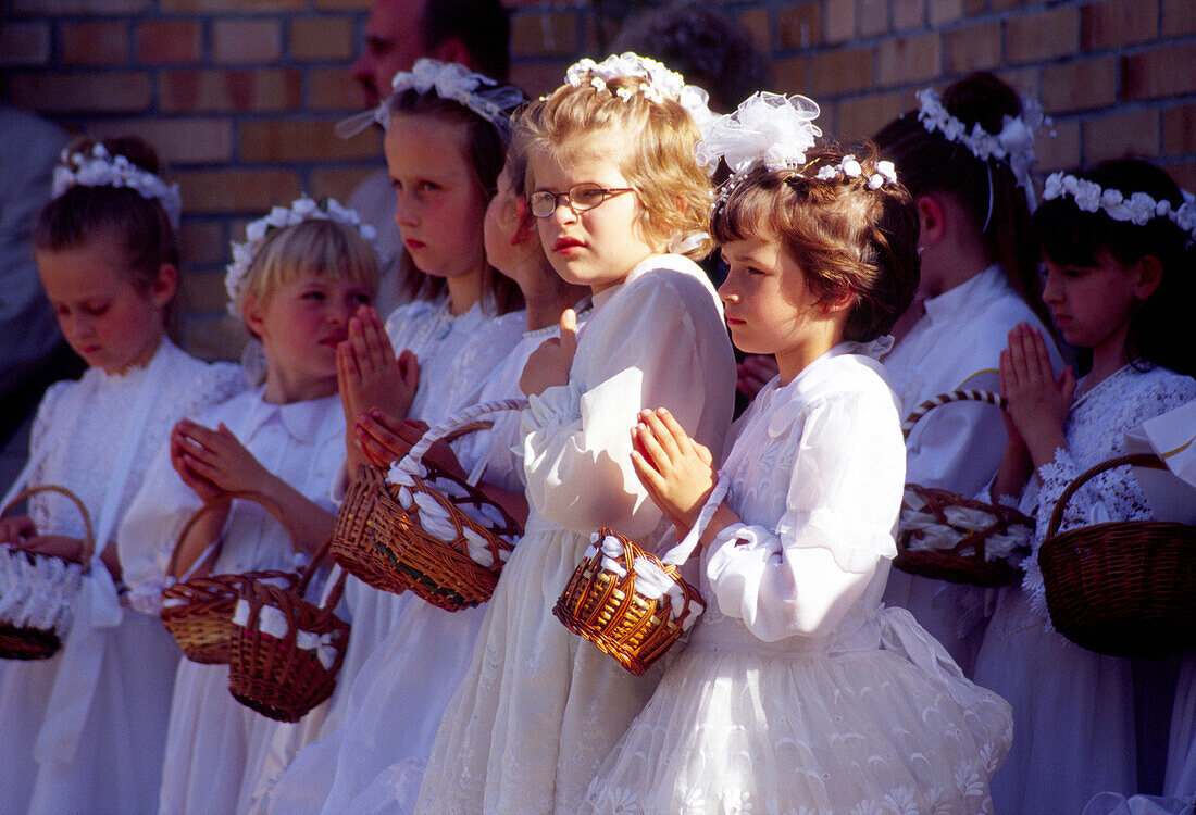 Young girls during the Procession on Flower Carpets for Corpus Christi in Spicimierz near Lodz, Poland