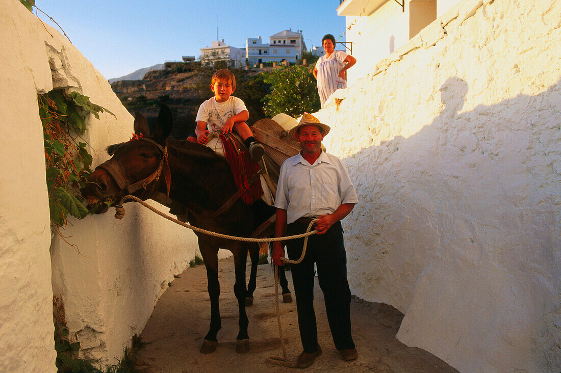 Farmer with child and donkey,Competa,white village,Province Malaga,Andalusia,Spain