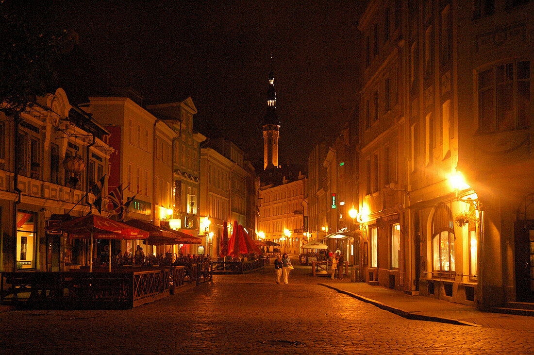 Viru Street at night with town hall tower, Tallinn, Estonia
