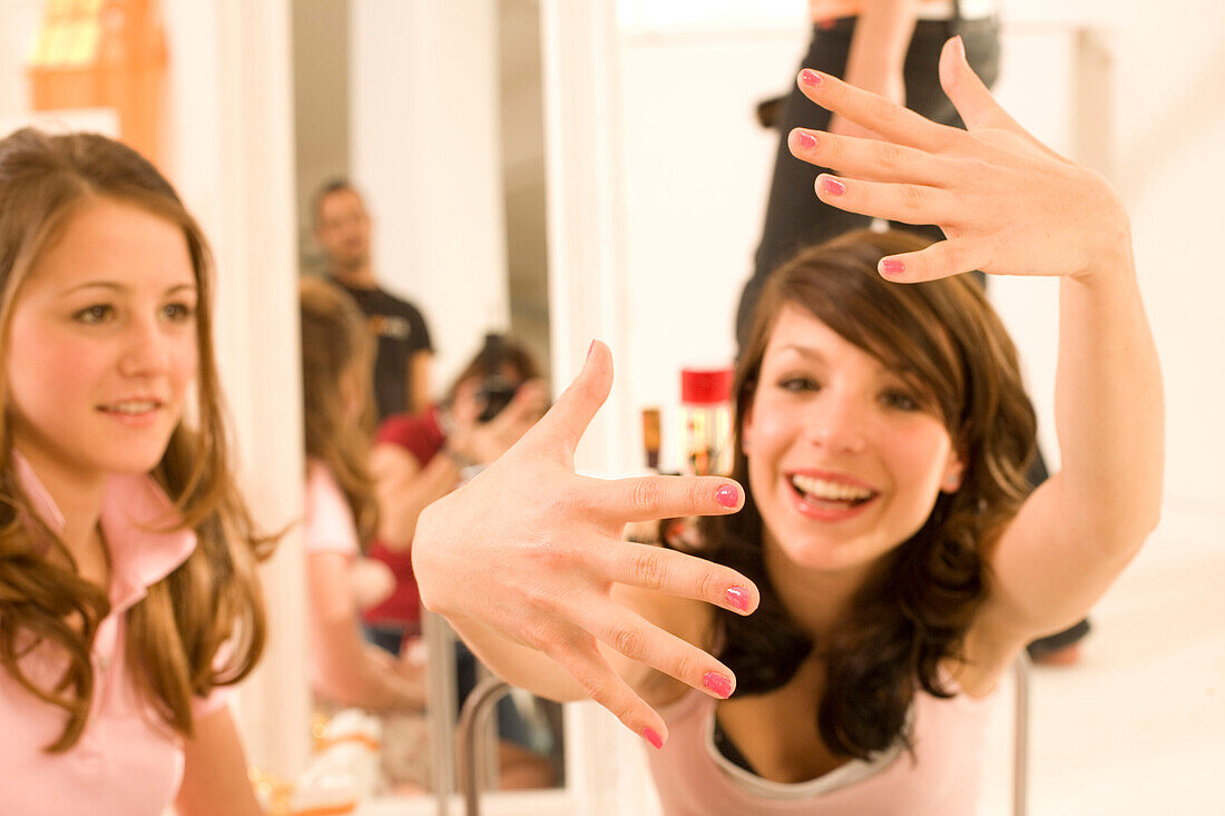 Teenage girl (14-16) showing her painted fingernails