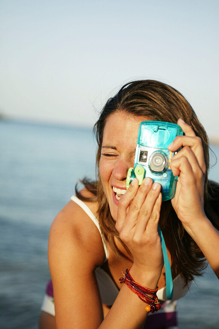 Young woman taking a picture with digital camera