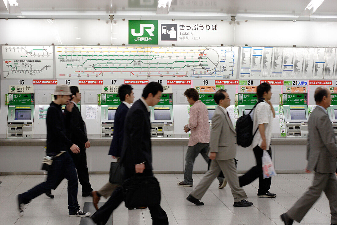 People in front of the ticket machine at a subway station, Tokyo, Japan