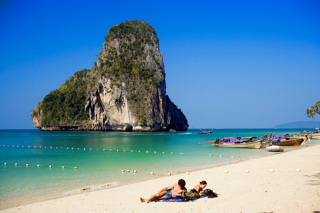 Tourists lying at white sandy beach, overgrown chalk cliff in background, Phra Nang Beach, Laem Phra Nang, Railay, Krabi, Thailand, after the tsunami