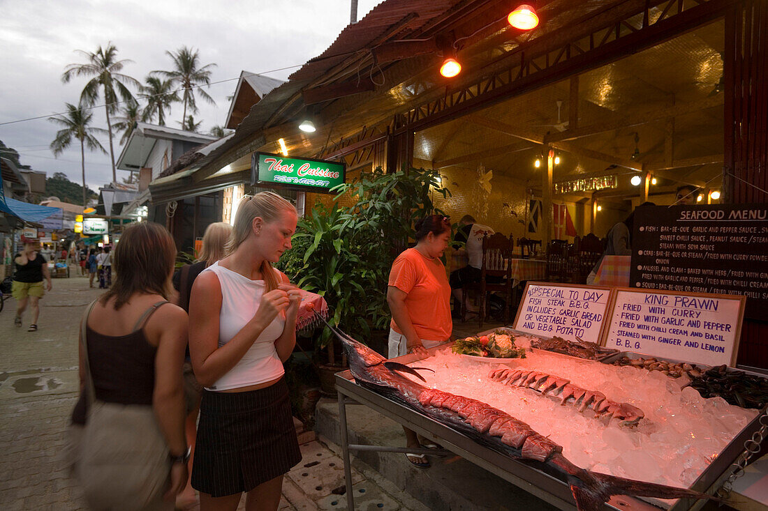 Two women in front of a fish restaurants, Ko Phi Phi Don, Ko Phi Phi Island, Krabi, Thailand, after the tsunami