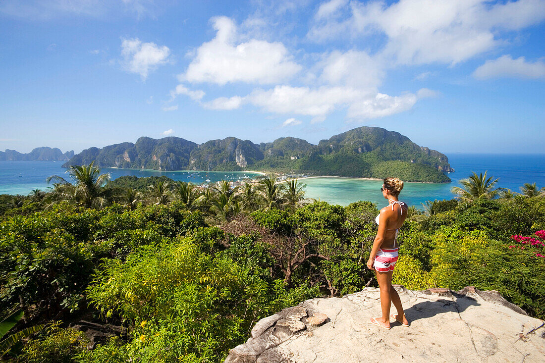 Young woman standing on Viewpoint and looking to Ao Lo Dalam and Ao Ton Sai, Ko Phi Phi Don, Ko Phi Phi Island, Krabi, Thailand