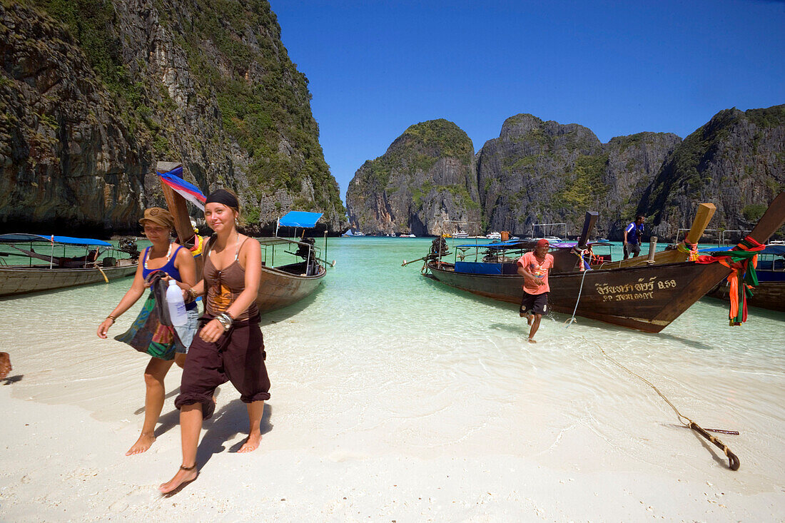 Tourists leaving long tail boats, Maya Bay, a beautiful scenic lagoon, famous for the Hollywood film "The Beach", Ko Phi-Phi Leh, Ko Phi-Phi Islands, Krabi, Thailand, after the tsunami