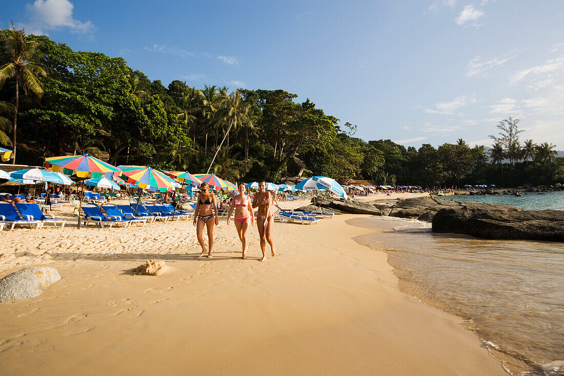Three girls walking over Laem Singh Beach, between Hat Surin and Hat Kamala, Phuket, Thailand, after the tsunami