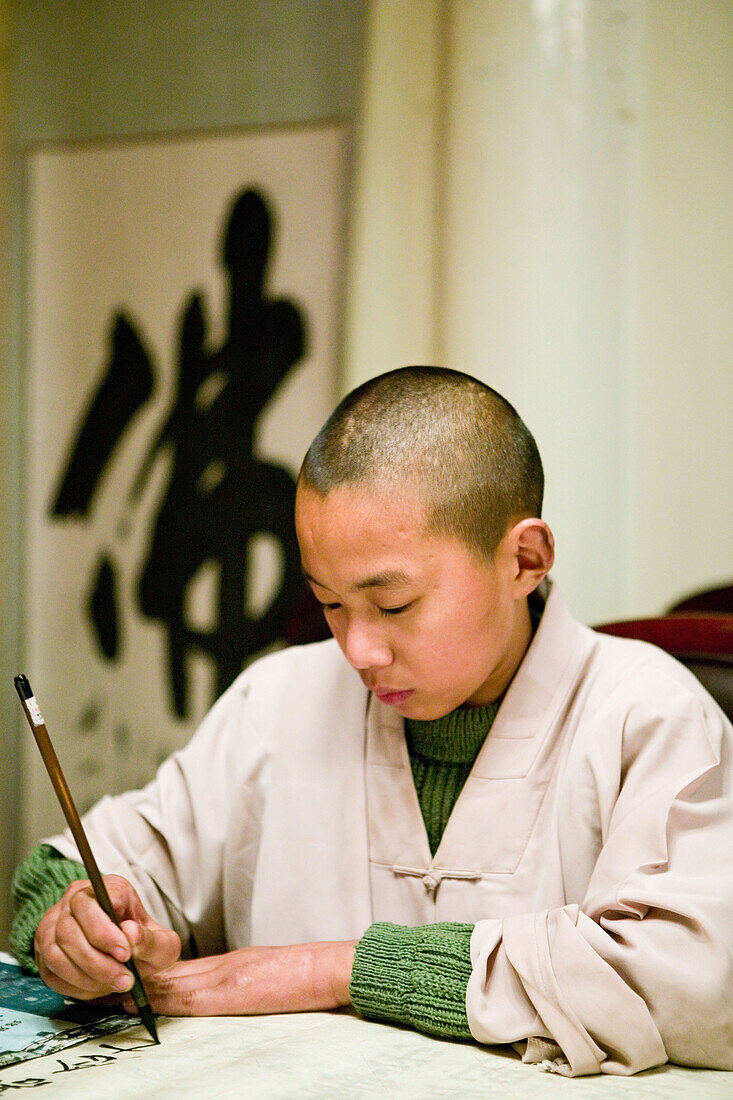 young monk with calligraphy brush, evening school, Xixiang Chi monastery and temple, Elephant Bathing Pool, China, Asia, World Heritage Site, UNESCO
