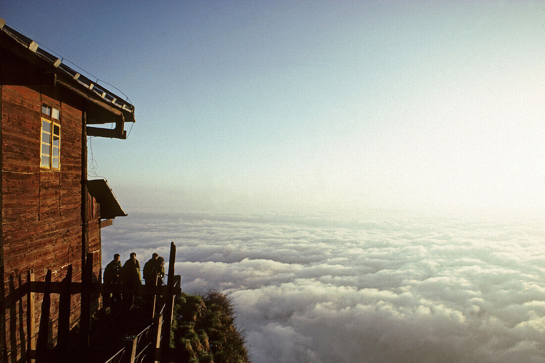 People in front of hostel of Jinding Monastery with view at sea of clouds, Emei Shan mountains, Sichuan province, China, Asia