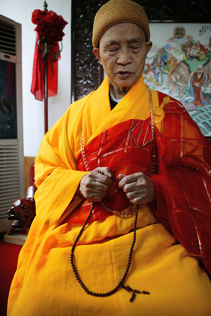 Praying abbot of Baotan Si monastery with prayer beads, Nantai, Heng Shan South, Hunan province, China, Asia