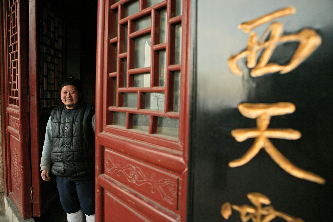 A monk standing in front of the temple, monastery at Golden Lock Pass, Hua Shan, Shaanxi province, China, Asia