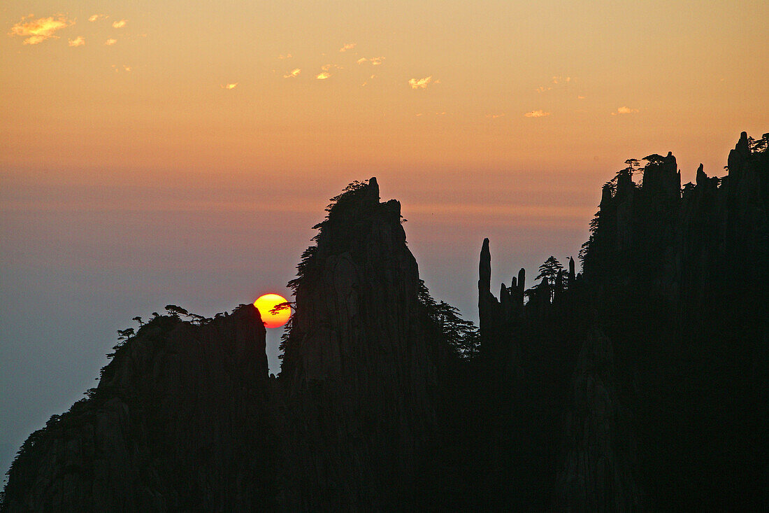 red sunrise with mountain silhouette, Northern Sea, Huang Shan, World Heritage, UNESCO, Anhui province, China, Asia