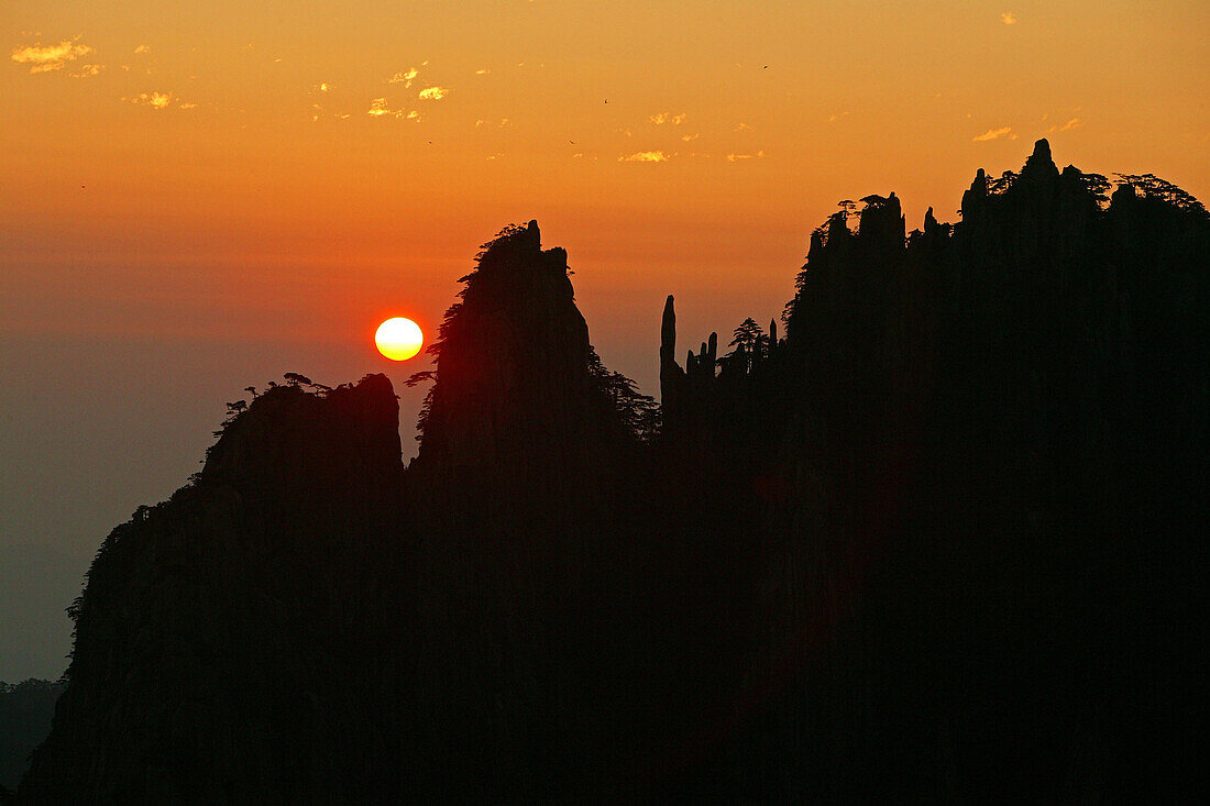 red sunrise with mountain silhouette, Northern Sea, Huang Shan, World Heritage, UNESCO, Anhui province, China, Asia