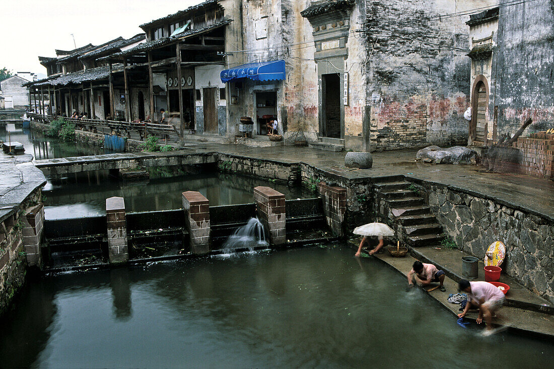 Women doing their laundry in a small dam at the village Tangmo, Huang Shan, China, Asia