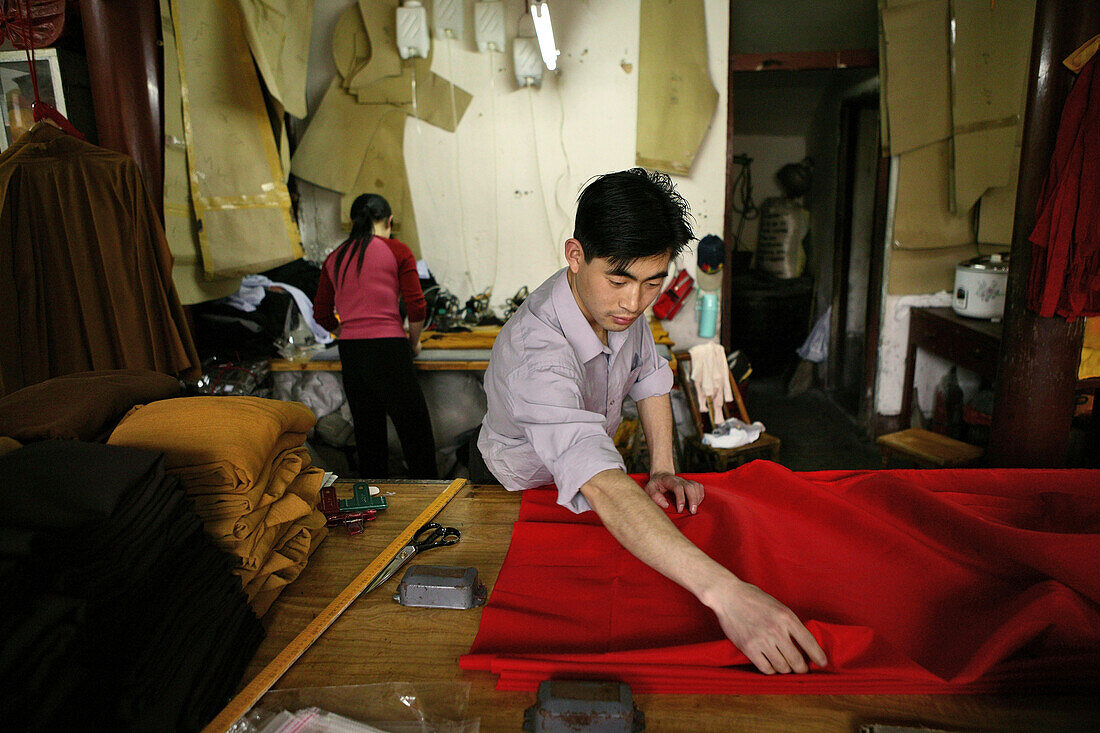 People working at a tailor shop for Buddhist monks robes, Jiuhuashan, Anhui province, China, Asia