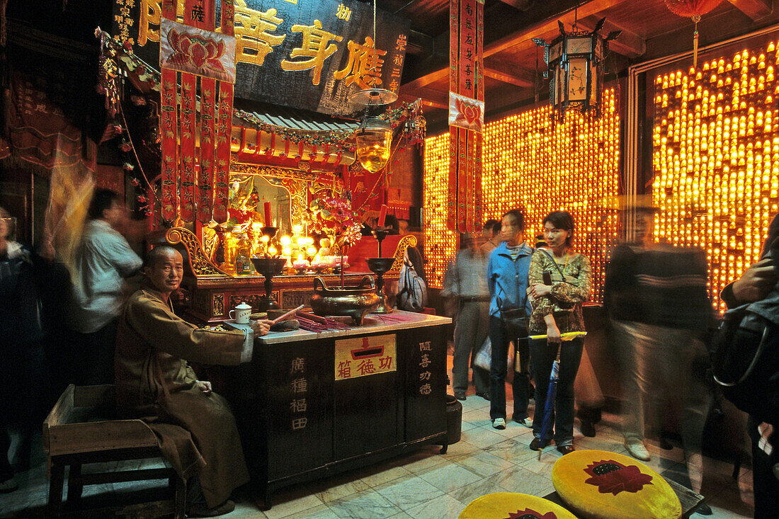 A monk and tourists at the temple of the Longevity monastery, Jiuhua Shan, Anhui province, China, Asia