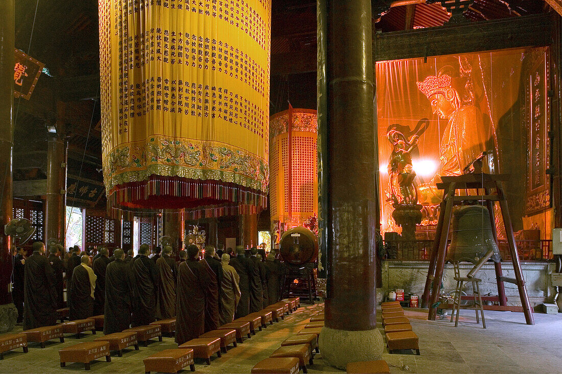 People standing in Dayuantong praying hall of the Puji Si monastery, Island of Putuo Shan, Zhejiang Province, China, Asia