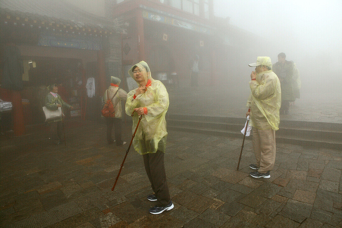 Pilgrims, tourists in rain capes at the entrance to Bixia Si temple, Mount Tai, Tai Shan, Shandong province, World Heritage, UNESCO, China