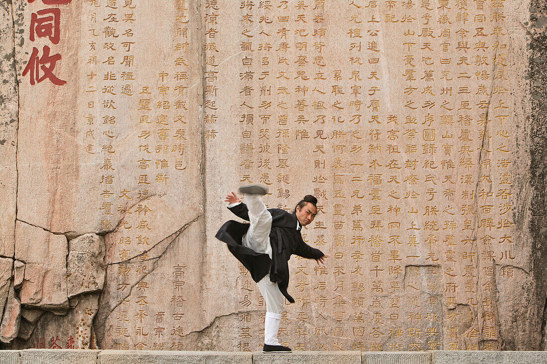 Taoist monk Zhang Qingren demonstrating Tai Ch infront of a famous inscription from Emperor Xuanzong, Hou Shi Wu Temple, Mount Tai, Tai Shan, Shandong province, World Heritage, UNESCO, China