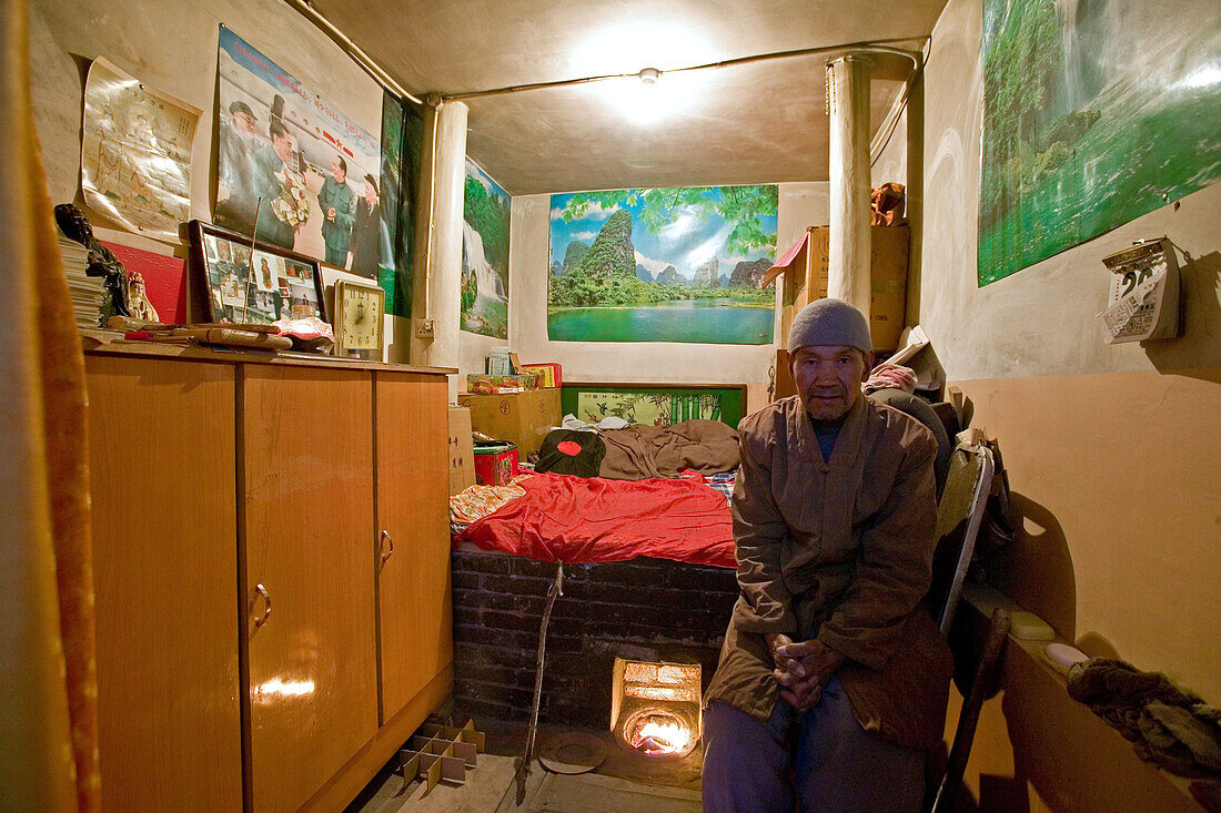 Temple guard in his room, heated bed, during birthday celebrations for Wenshu, Shuxiang Temple, Mount Wutai, Wutai Shan, Five Terrace Mountain, Buddhist Centre, town of Taihuai, Shanxi province, China