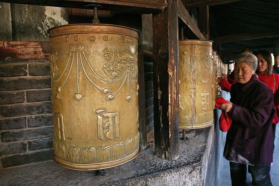 pilgrims circle and turn the prayer wheels at the base of the Great White Pagoda, during birthday of Wenshu, Monastery, Wutai Shan, Five Terrace Mountain, Buddhist Centre, town of Taihuai, Shanxi province, China, Asia