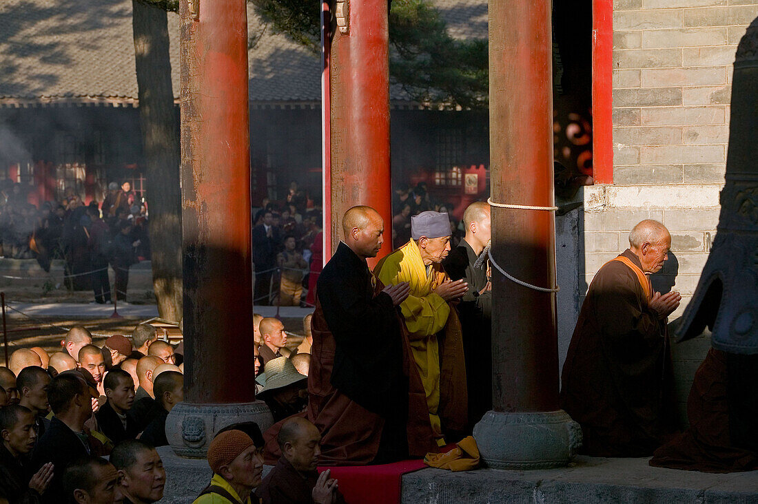 Buddhist monks honouring Wenshus the birthday celebrations, red columns of temple, Xiantong Monastery, Wutai Shan, Five Terrace Mountain, Buddhist Centre, town of Taihuai, Shanxi province, China