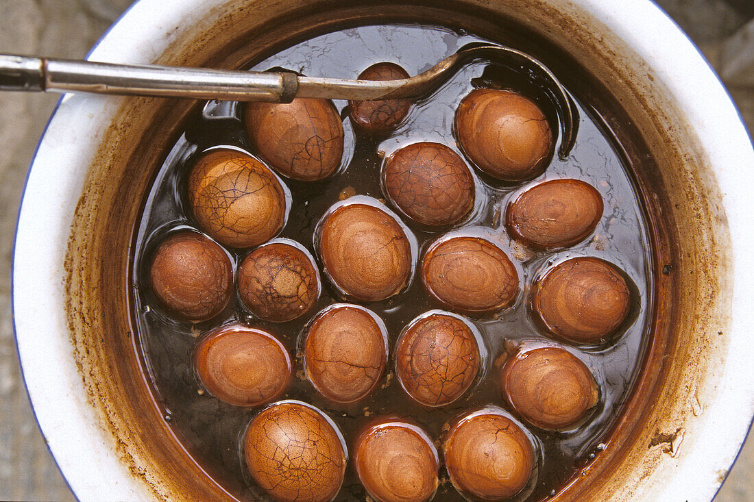 Tee Eier, hart gekochte Eier in einem Sud aus schwarzem Tee, Sojasauce und Gewürzen gekocht, typischer Imbiss, Marmorierte Eier, China, Asien