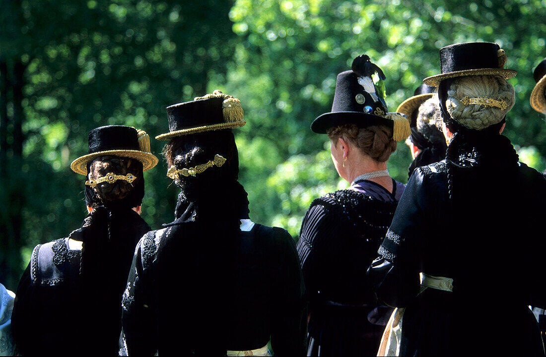 group of women in dirndl dresses from the backside with traditional hats, pilgrimage to Raiten, Schleching, Chiemgau, Upper Bavaria, Bavaria, Germany