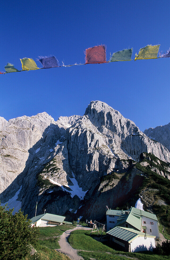 Stripsenjoch alm with Totenkirchl and Buddhist prayer flags, Stripsenjochhaus, Kaiser mountain range, Tyrol, Austria