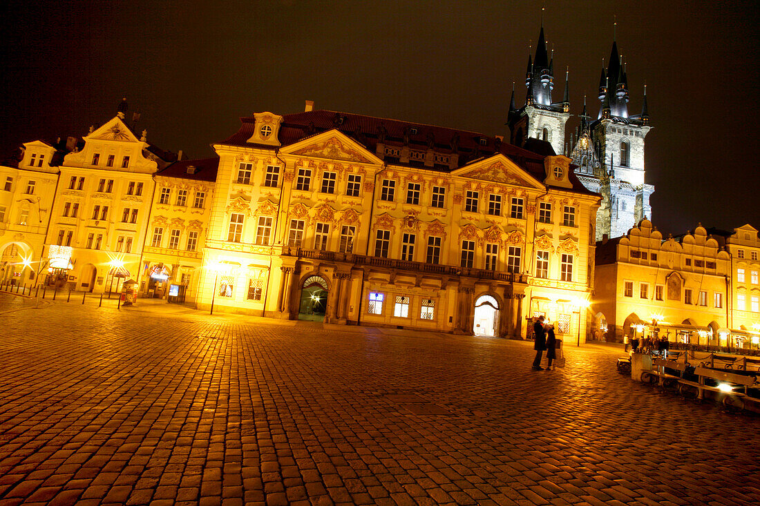 A couple in an empty square, Tyn church, Stare Mesto, Old Town Square, Prague, Czech Republic