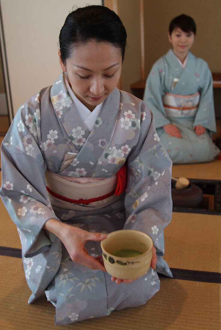 Two Japanese women preparing the tea ceremony in Hosomi museum, Kyoto, Japan