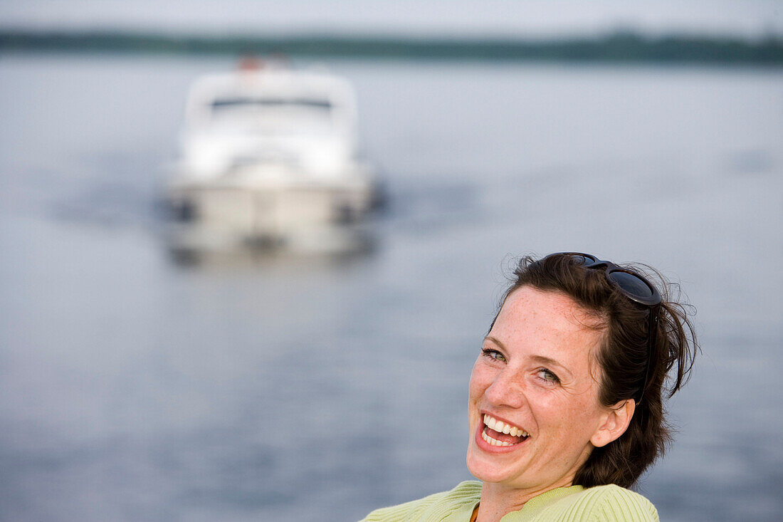 Smiling woman on houseboat, Grosser Storkower See near Storkow, Brandenburg, Germany