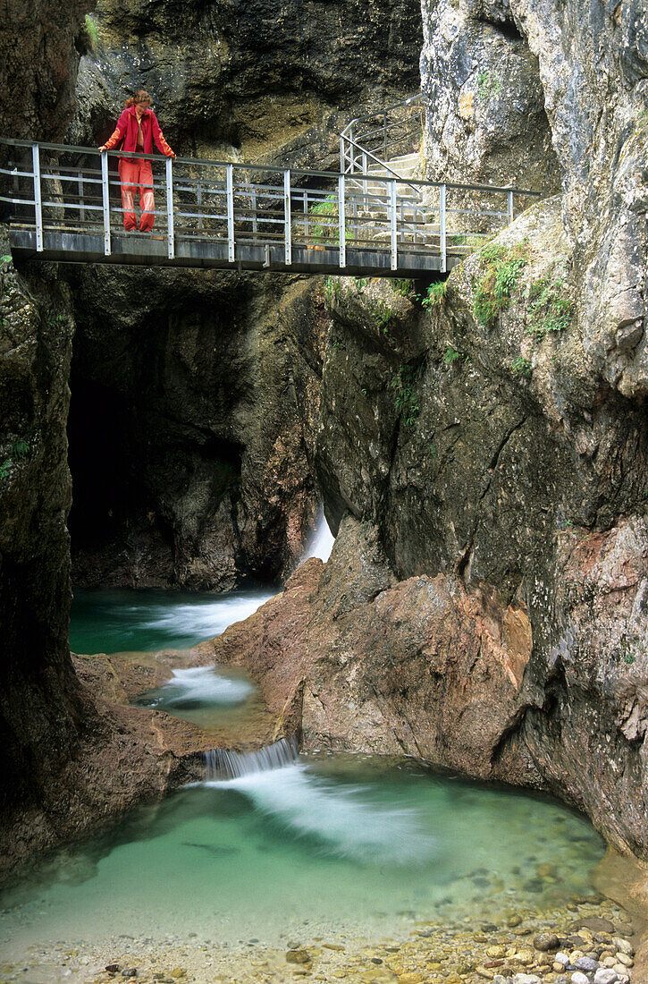 hiker on bridge through canyon Almbachklamm, Berchtesgaden, Upper Bavaria, Bavaria, Germany