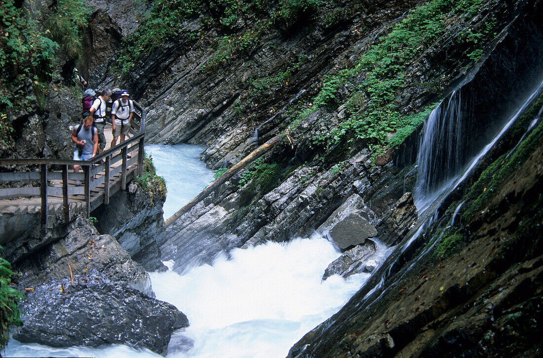 hiker on bridge through canyon Wimbachklamm, Berchtesgaden, Upper Bavaria, Bavaria, Germany