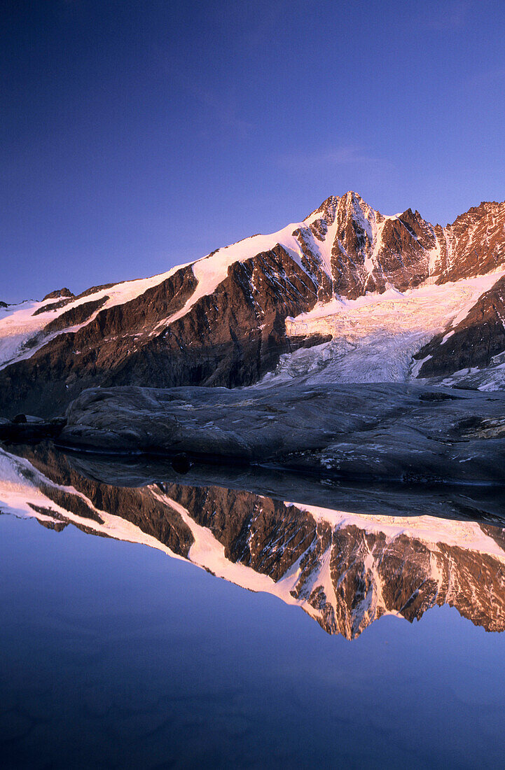 Großglockner im Morgenlicht mit Spiegelung im Bergsee, Glocknergruppe, Nationalpark Hohe Tauern, Kärnten, Österreich