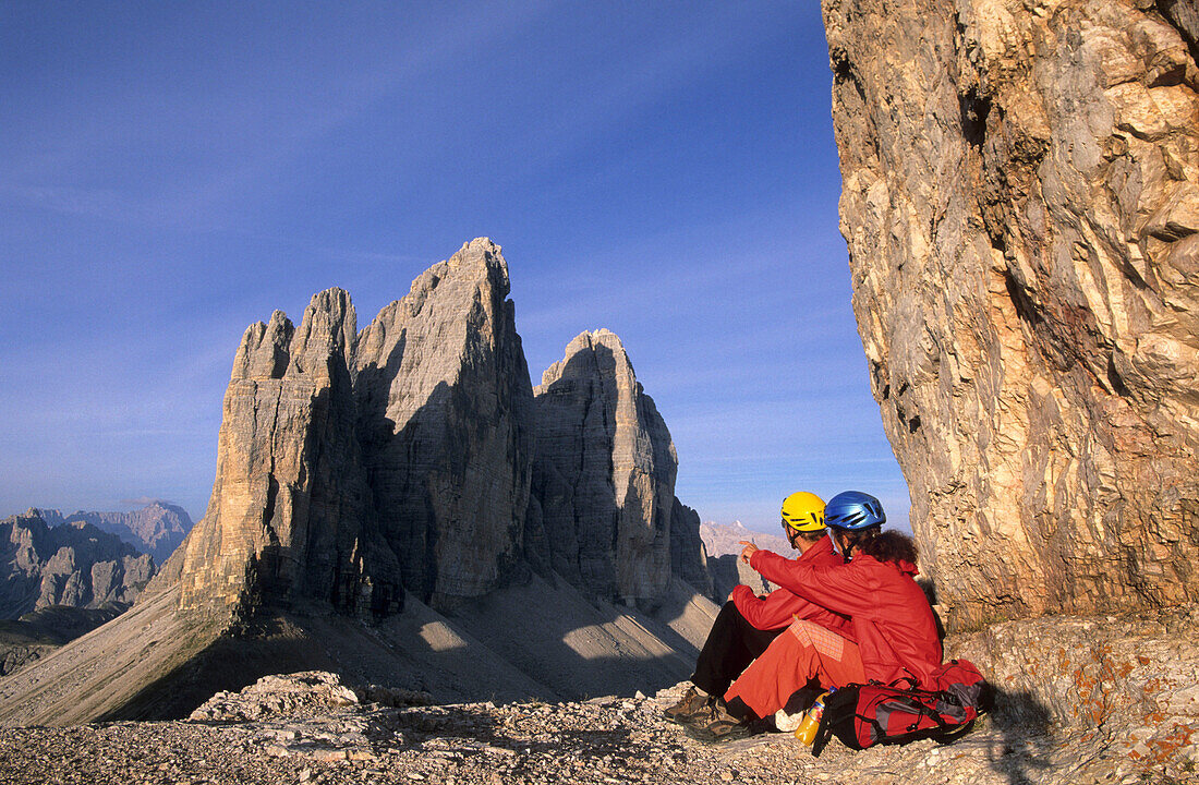 Two mountaineers in front of Drei Zinnen, Dolomites, South Tyrol, Italy