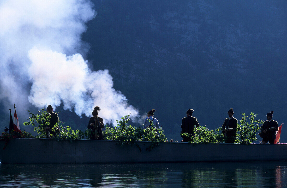 Shooting rifles from a boat on lake Hallstaetter See at Corpus Christi, Hallstatt, Salzkammergut, Upper Austria, Austria