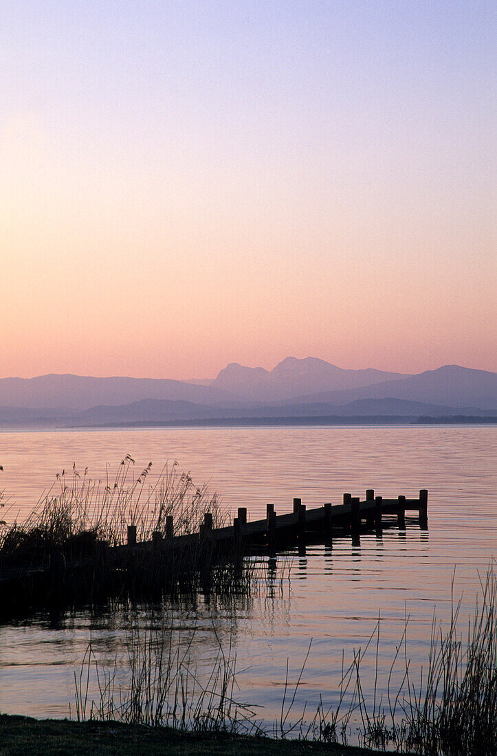 Landing stage in Gstadt at dawn with Hochstaufen and Zwiesel, lake Chiemsee, Chiemgau, Upper Bavaria, Bavaria, Germany