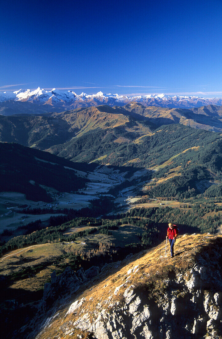mountaineerer at Taghaube above Erichhütte with view to Hohe Tauern, Hochkönig area, Berchtesgaden range, Salzburg, Austria