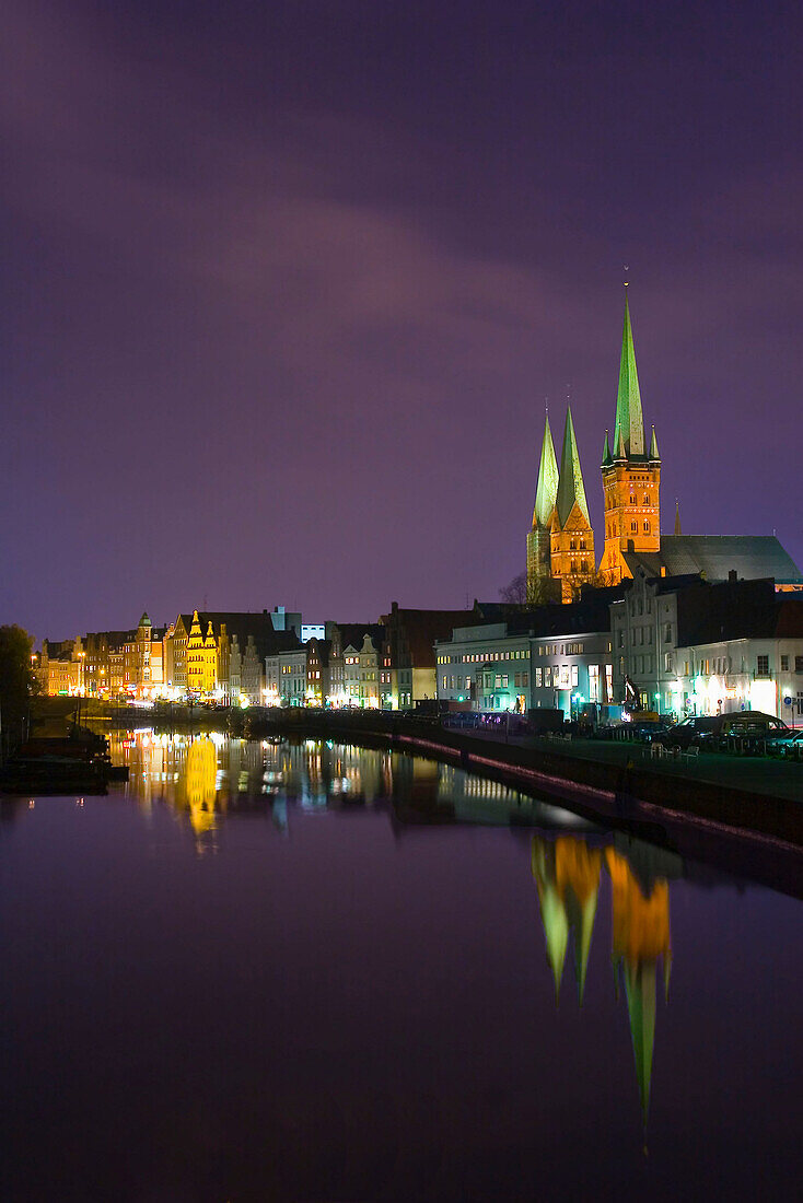 View over Trave River to old town at night, Schleswig-Holstein, Germany