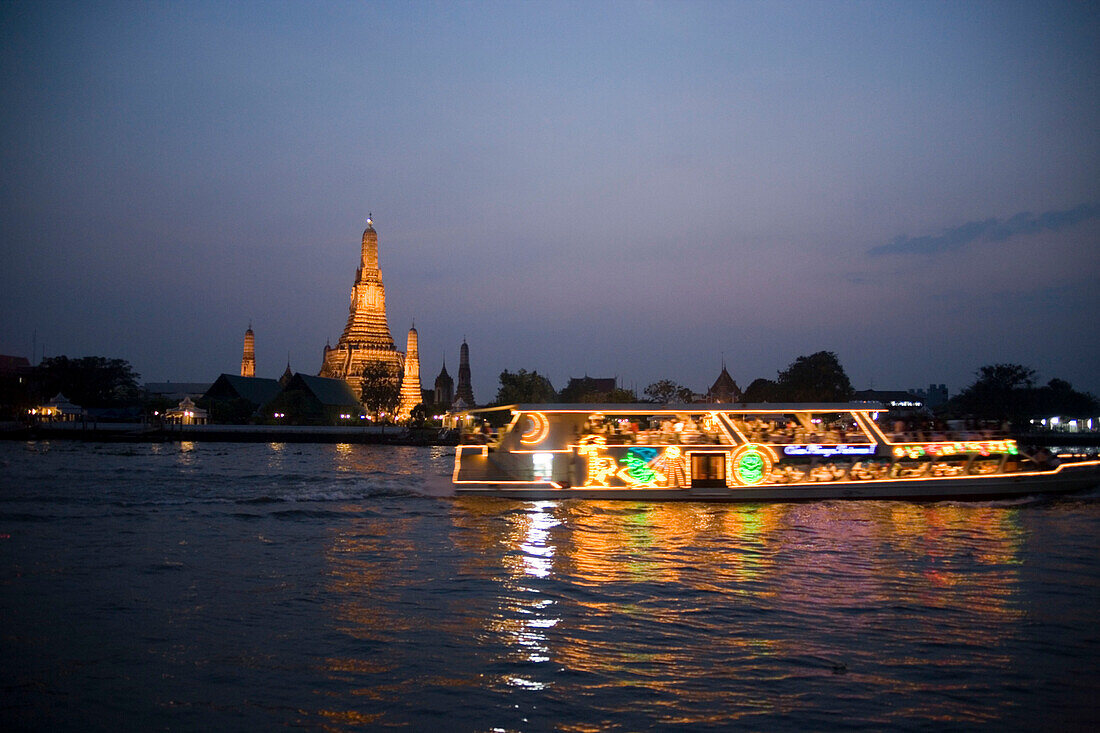 View over the river Menam Chao Phraya with a restaurant ship to Wat Arun, Temple of Dawn, Bangkok, Thailand