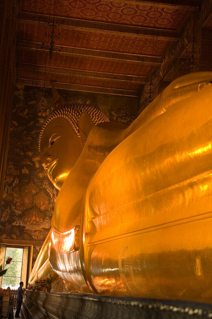 View along the golden Reclining Buddha, Wat Pho, The Temple of the Reclining Buddha, the largest and oldest wat in Bangkok, Bangkok, Thailand