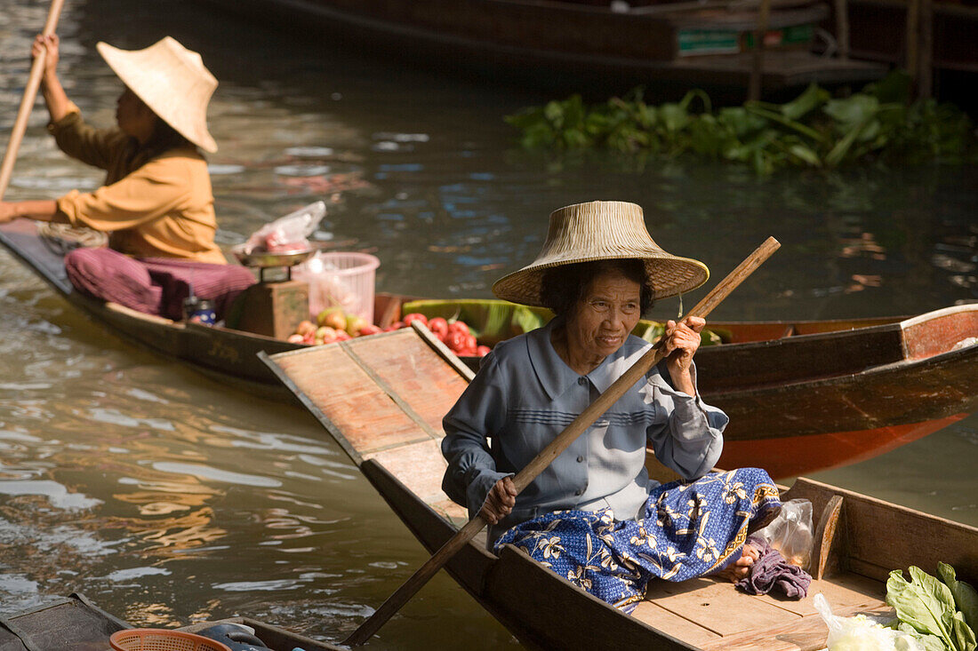 Women in wooden canoes at Floating Market, Damnoen Saduak, near Bangkok, Ratchaburi, Thailand