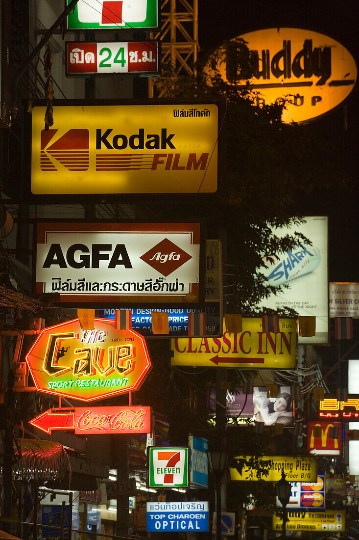 Illuminated signs along Th Khao San Road at night, Banglamphu, Bangkok, Thailand