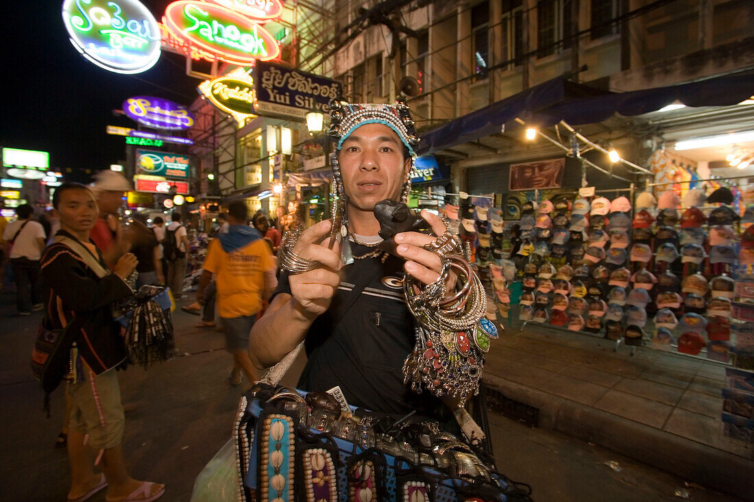 Sounding frog seller offering at Th Khao San Road in the evening, Banglamphu, Bangkok, Thailand